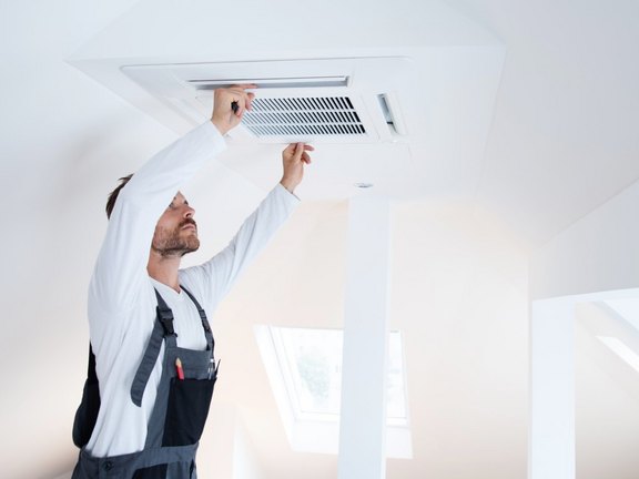 Mann installiert Lüftungsanlage